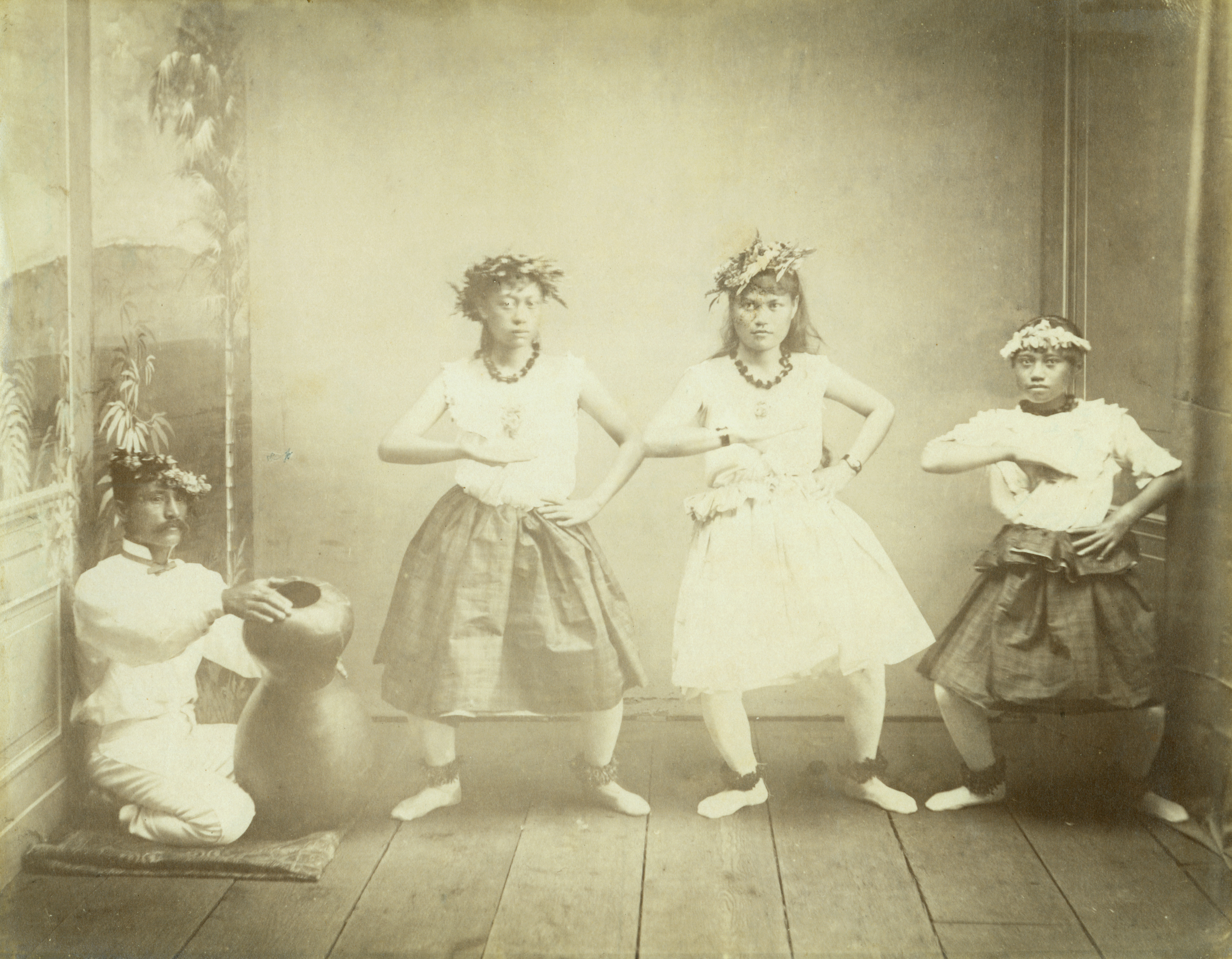 [Hula dancers and chanter] Hawaiʻi, ca. 1880. Photo by H. L. Chase.