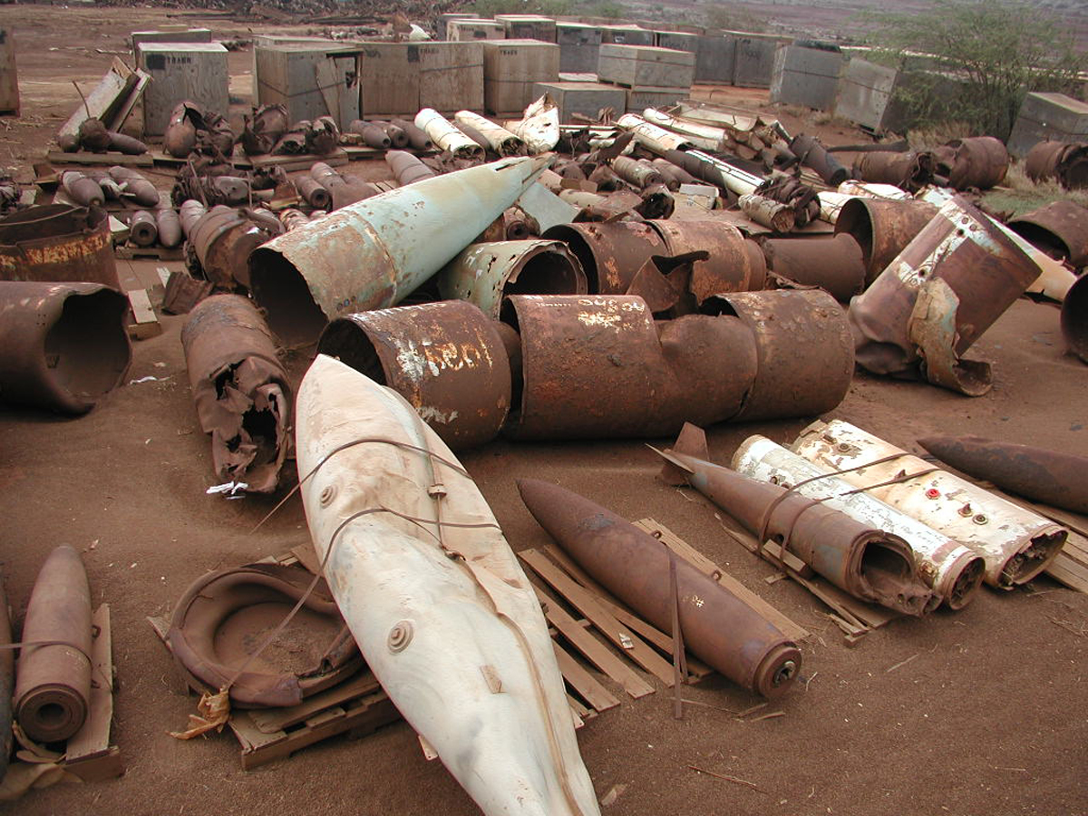 [Unexploded bombs] Unexploded ordnance and scrap metal on Kahoʻolawe in 2003. Photo by Michael Gawley.